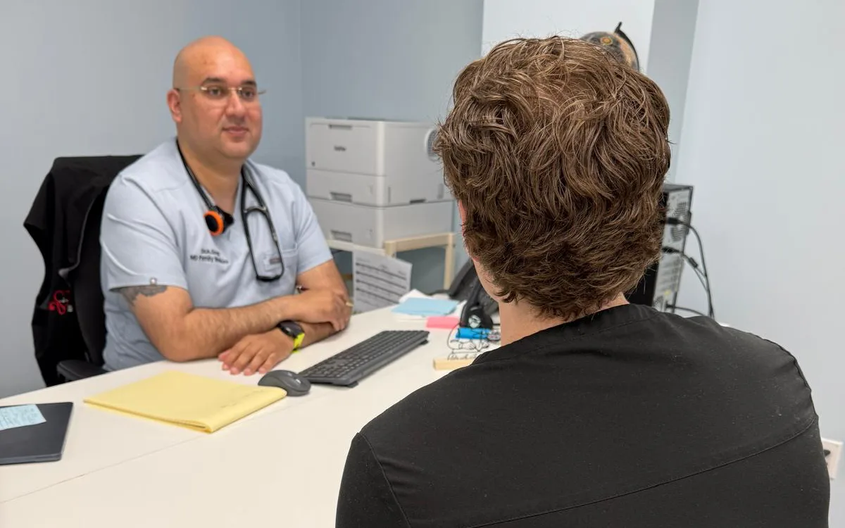 Dr. Andy Singh speaking with a patient during a family medicine consultation