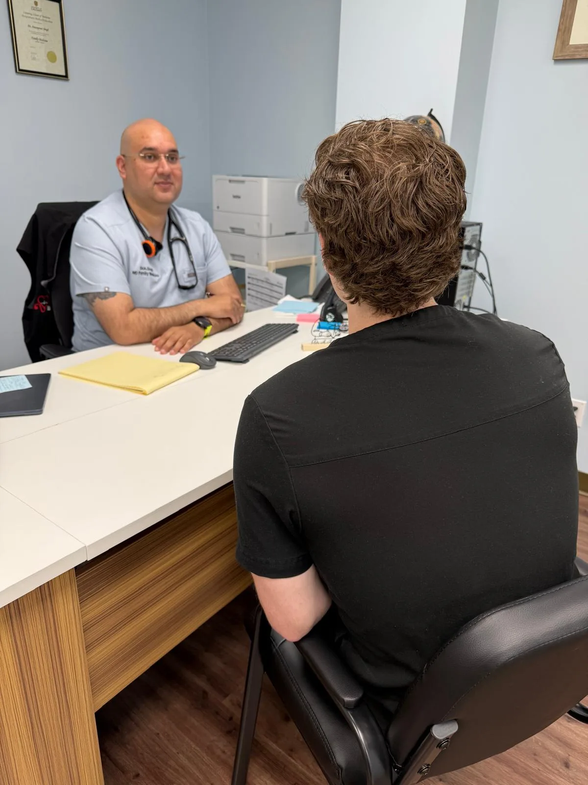 Dr. Andy Singh speaking with a patient during a family medicine consultation