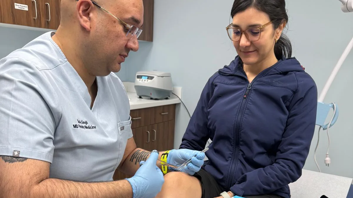 Dr. Andy Singh providing an orthopedic injection treatment in the clinic