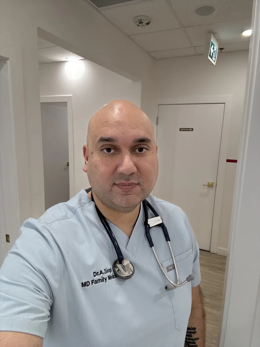 Dr. Andy Singh wearing scrubs and a stethoscope